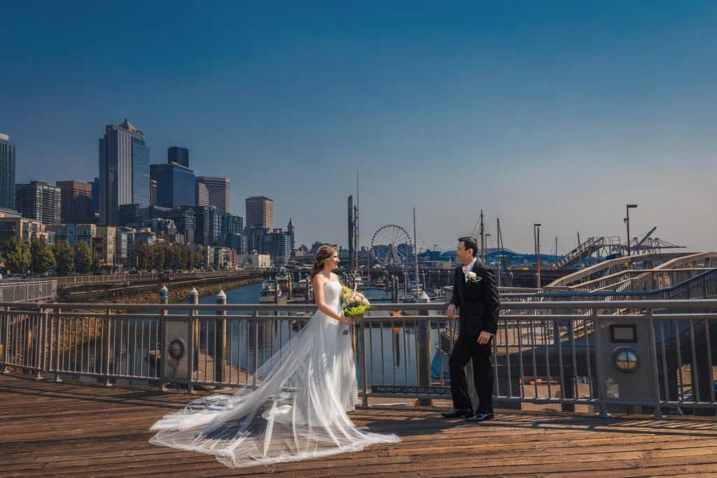 Wedding photographers take pictures of wedding couples at Seattle water front